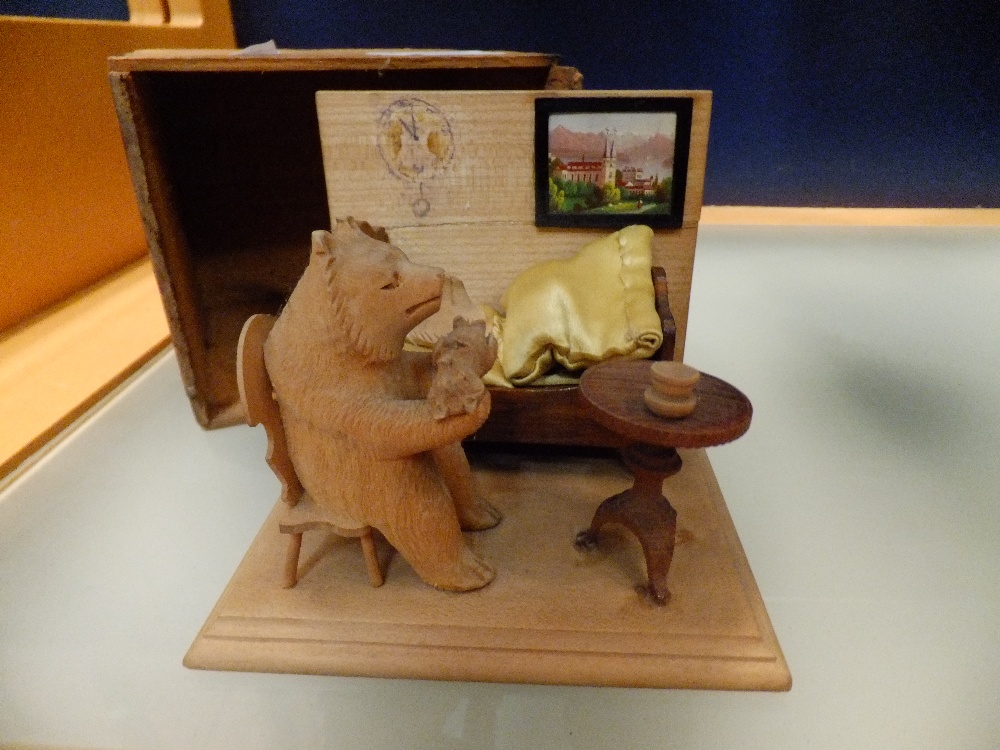 A carved Black forest bear in a bedroom scene in a presentation box