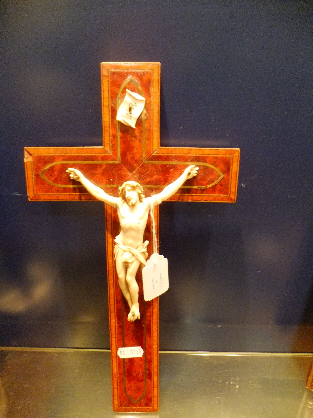 A burr walnut cross-banded Crucifix with carved ivory figure