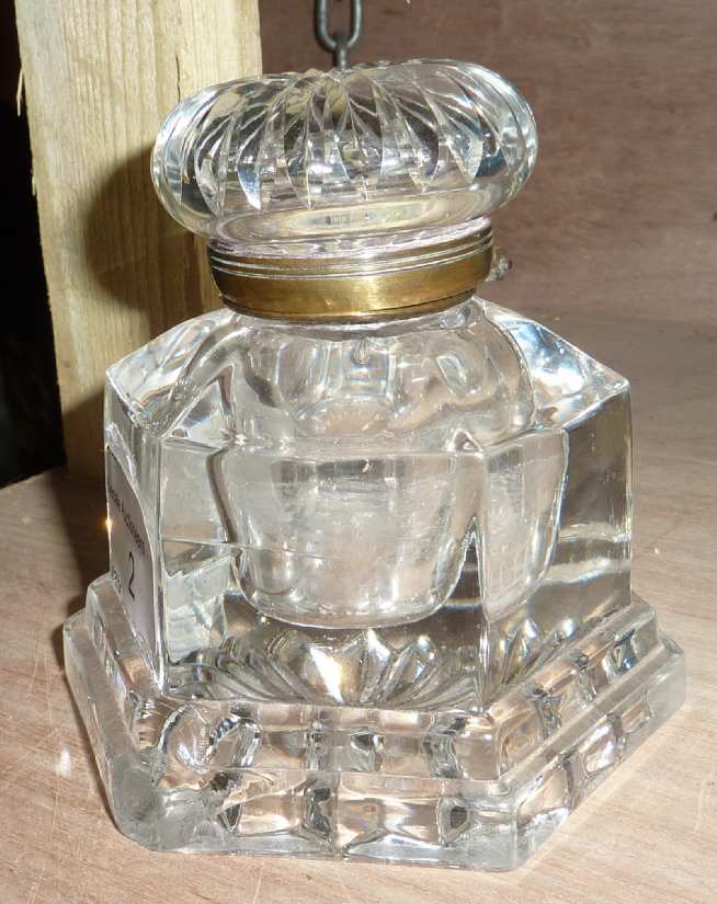 Glass ink well with hinged brass rimmed top