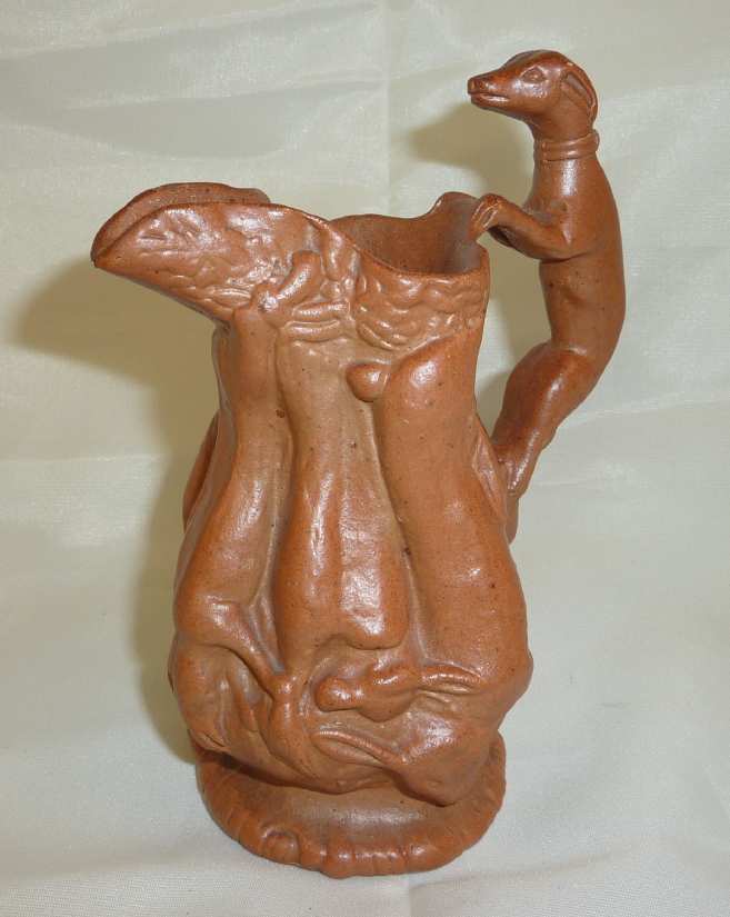 Small Brampton stoneware jug with relief moulded foxes and fox handle