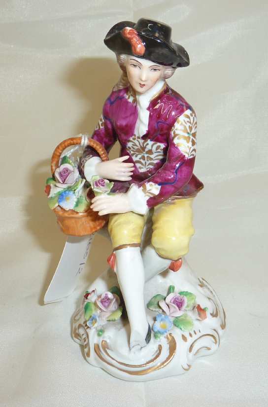 Sitzendorf figurine of young man with basket flowers (a/f)