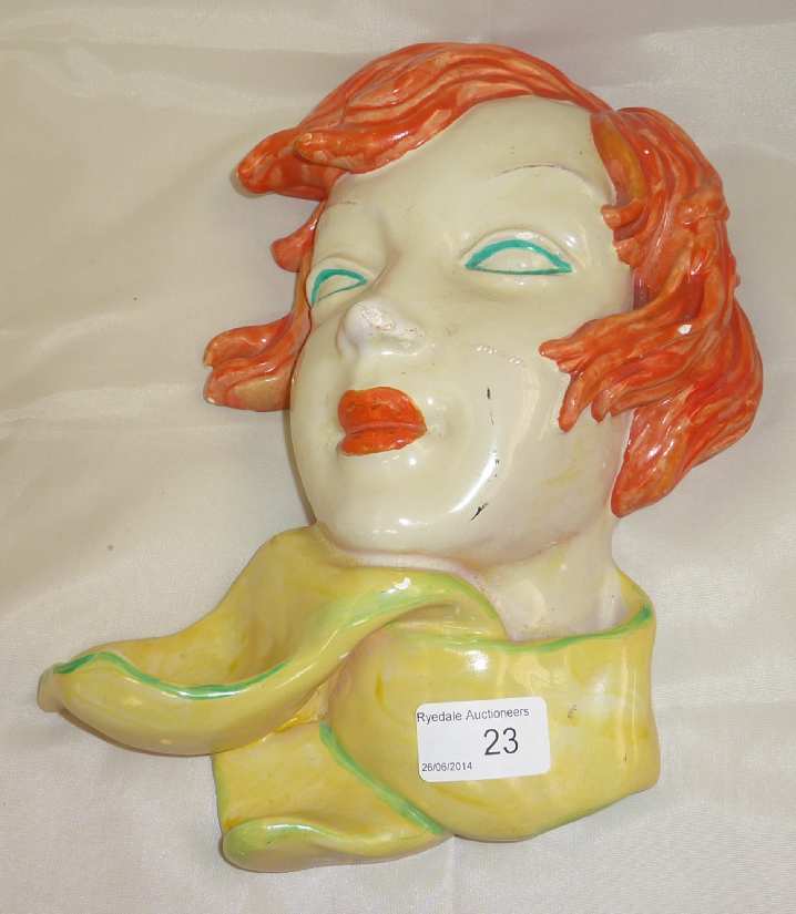 Goldschneider style wall mounted ceramic mask of a red headed female, the back with impressed