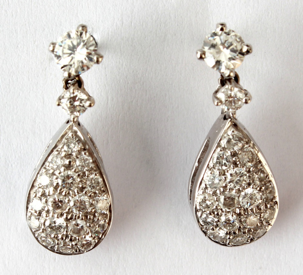 A pair of 18ct white gold diamond pave set pear shaped drop earrings, the estimated total diamond