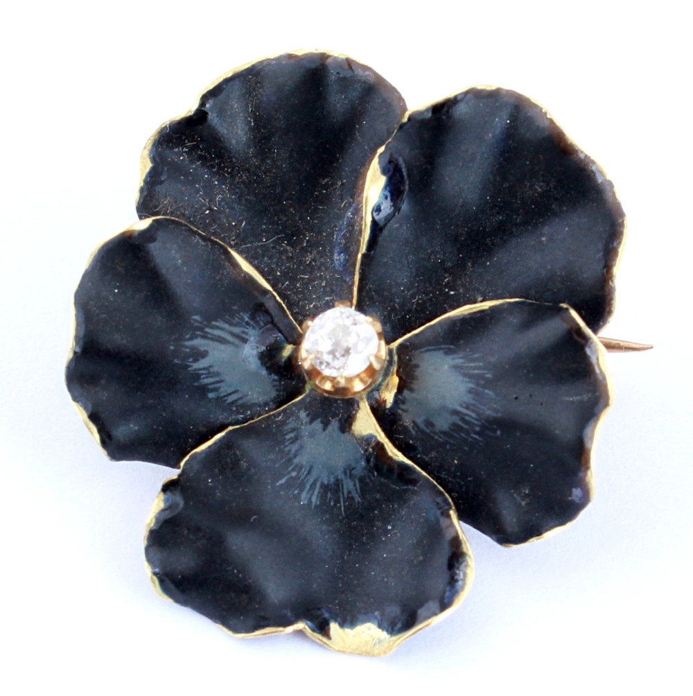 A black enamel & diamond flowerhead brooch, French mark to pin, 1.05ins. (2.65cms.) across (see