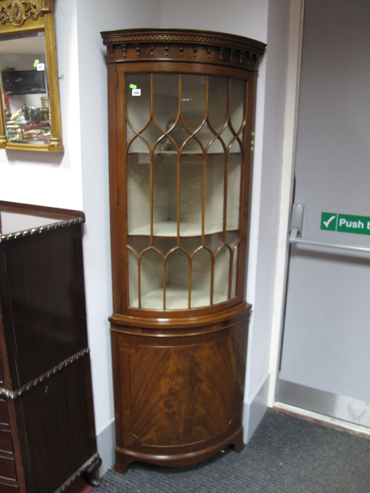 A XX Century Mahogany Bow Fronted Corner Cupboard, with a dentil cornice, glazed door over bow