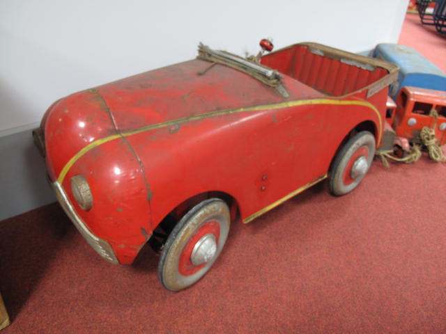 A Mid XX Century English Child`s Pedal Car, finished in red with yellow stripe, although significant