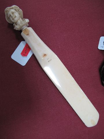 A Late XIX Century French Ivory Letter Opener, the handle carved with a bust of a young peasant boy