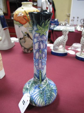 A Moorcroft Pottery Vase, designed by Rachel Bishop, with blue flowerheads to the elongated neck