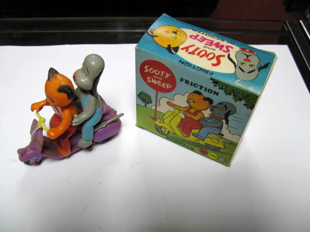 A 1970`s Plastic Friction Drive Sooty and Sweep Scooter by Marx. Appears unbroken. Boxed with