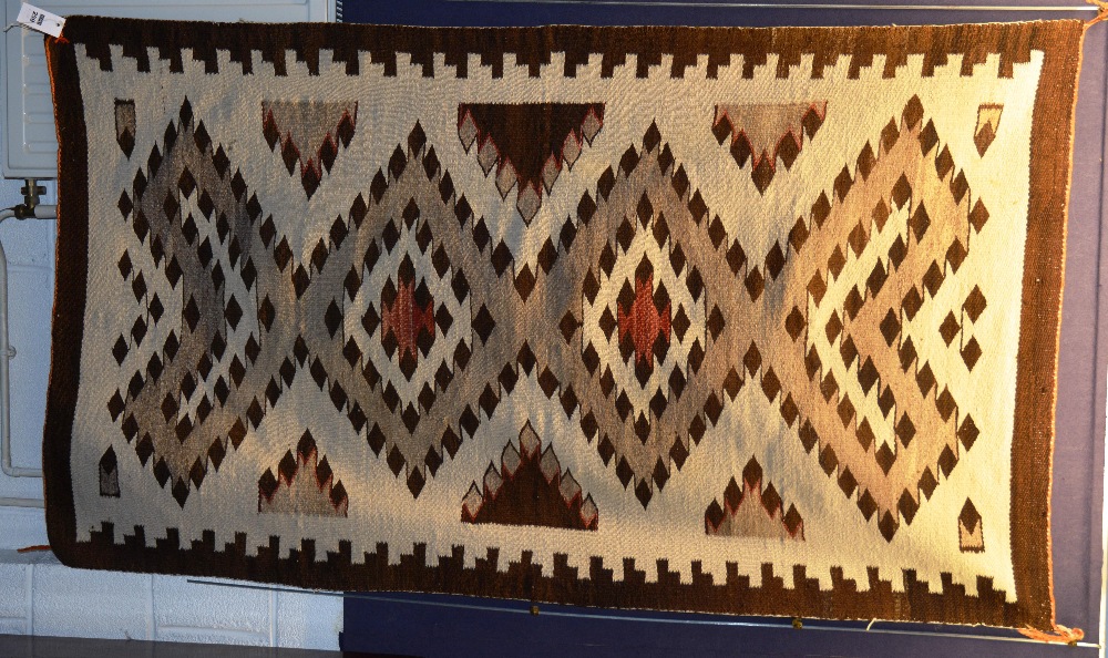 An early 20th century Transitional Navajo rug/wall hanging, with allover diamond design on cream
