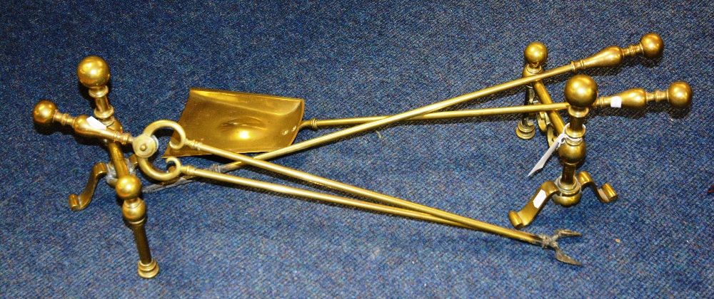 A pair of brass fire dogs and fire irons, with poker, tongs and shovel (5)