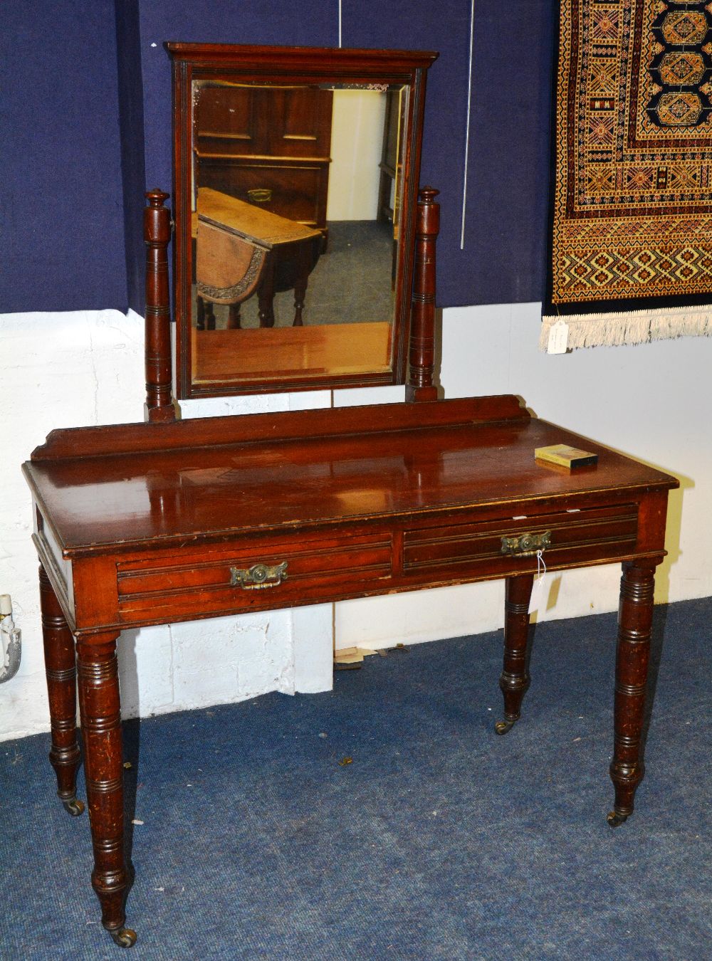 An Edwardian mahogany dressing table, the rectangular swing mirror over moulded rectangular top with
