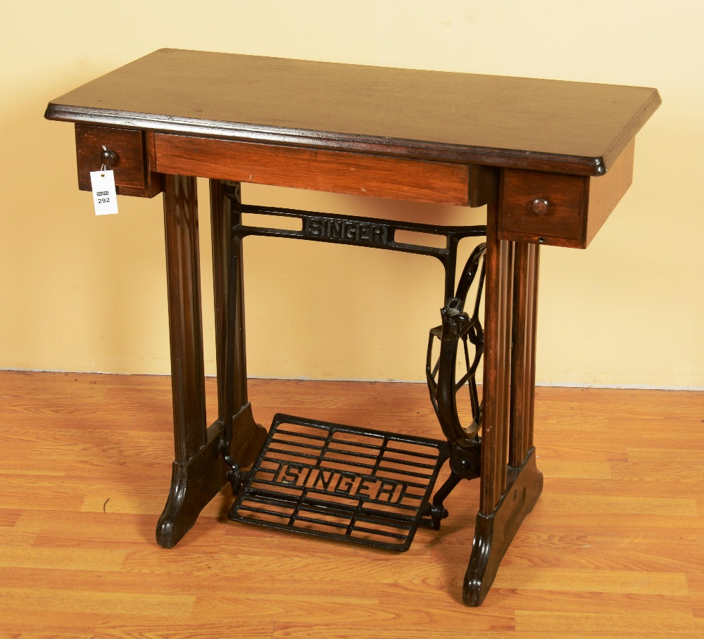 A Singer sewing table, the rectangular top on shaped legs, fitted with pedal and frame, 86cm wide