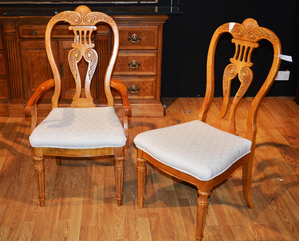 A set of six dining chairs, each with floral and shell carved top rail, pierced vase shaped splat,