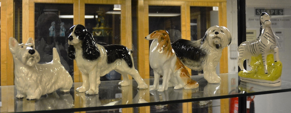 Four various ceramic dogs, including Staffordshire flat back zebra (5)
