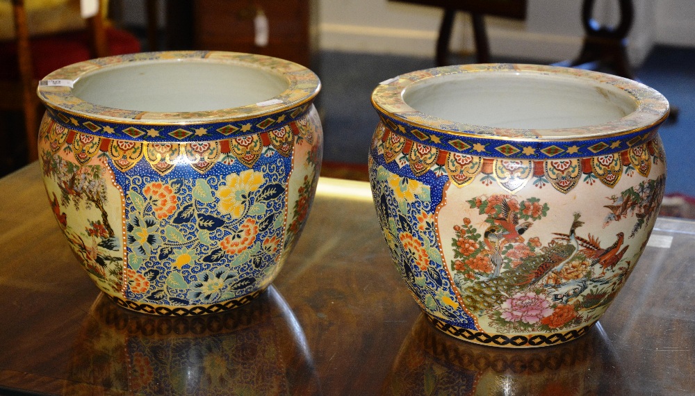 A pair of large Satsuma style vases, decorated with exotic birds and floral borders, with fish to