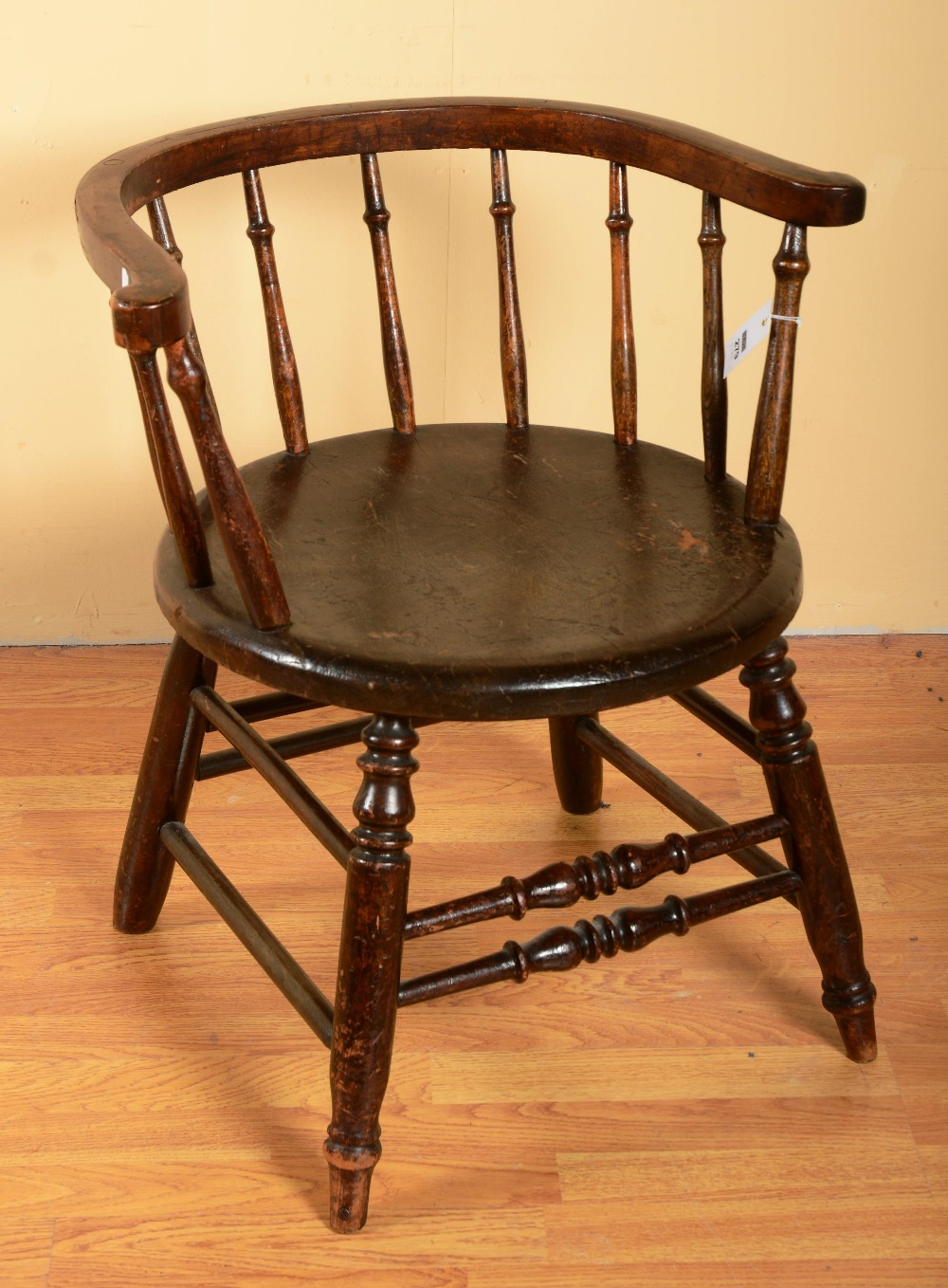 A Windsor tub chair, with hoop top rail, baluster splats, circular seat raised on splayed baluster