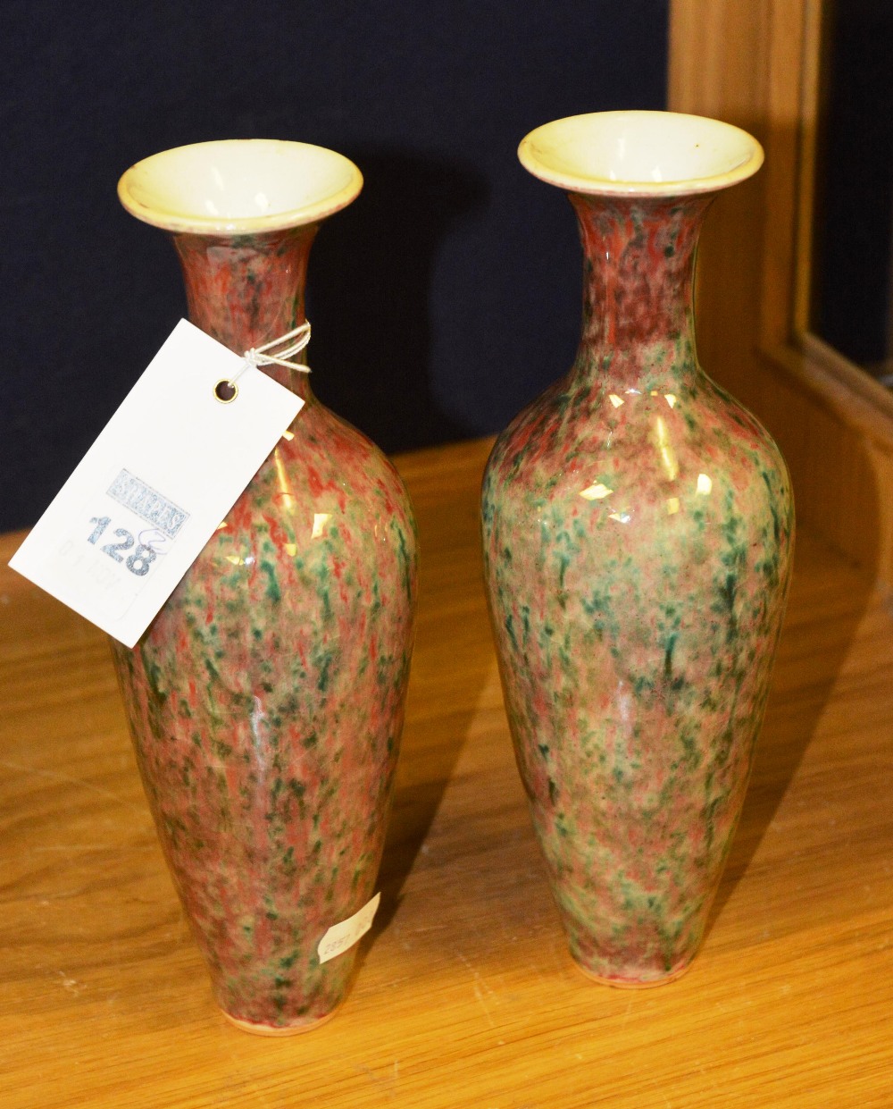 A pair of Chinese vases, each with flared lip, green and red dappled glaze, 23cm high (2)