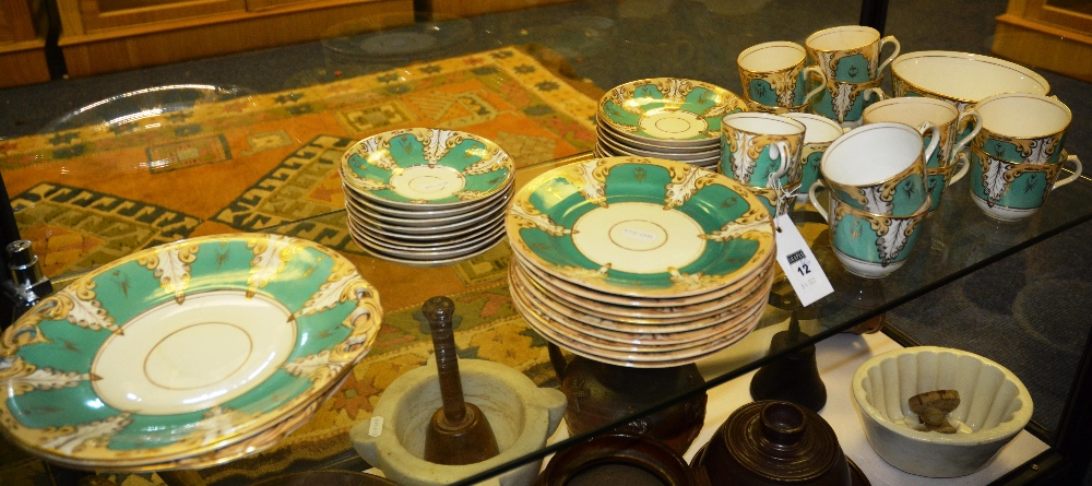 A part teaset, decorated in gilt and green floral decoration, comprising cups, saucers, plates,