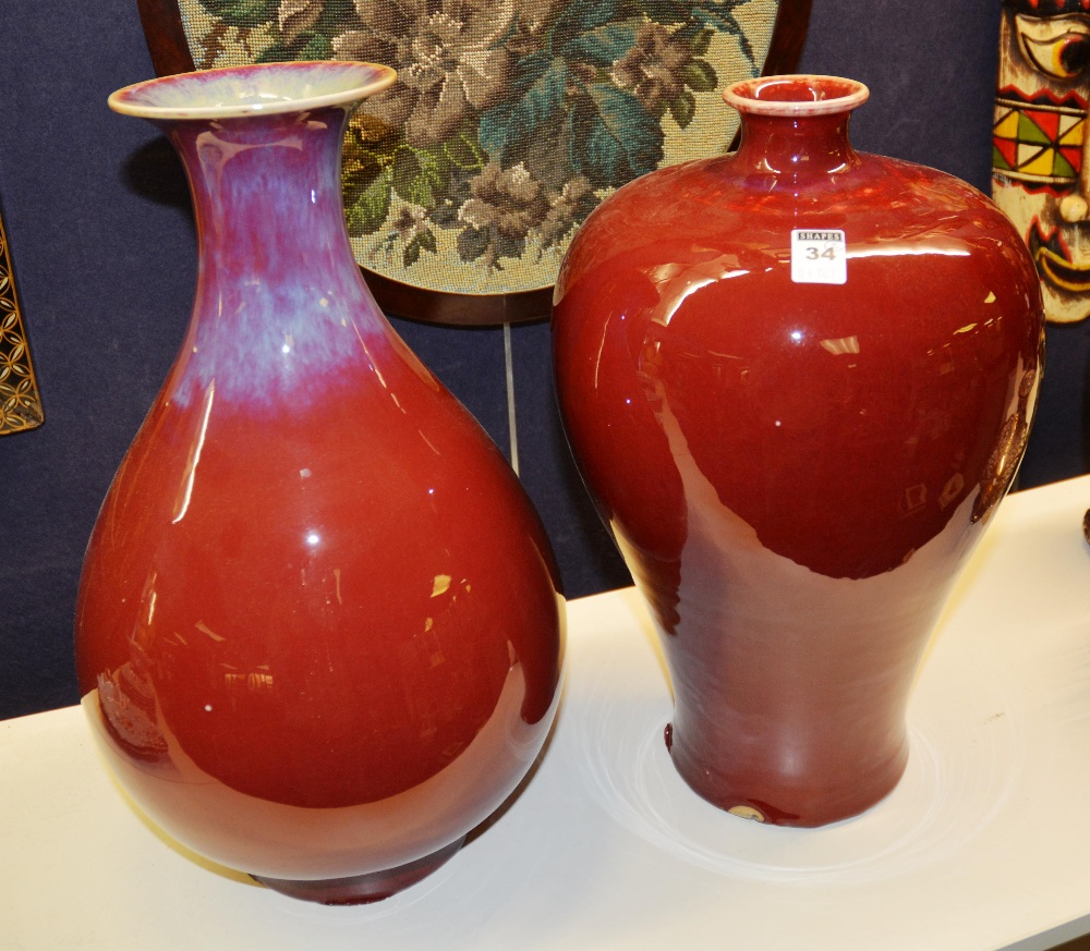 Two sang de boef vases, with marks to base of one, 40cm high & 39cm high