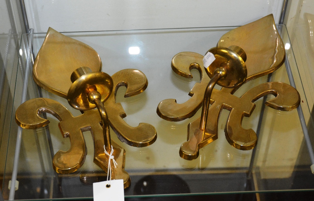 A pair of brass fleur de lys wall sconces (2)