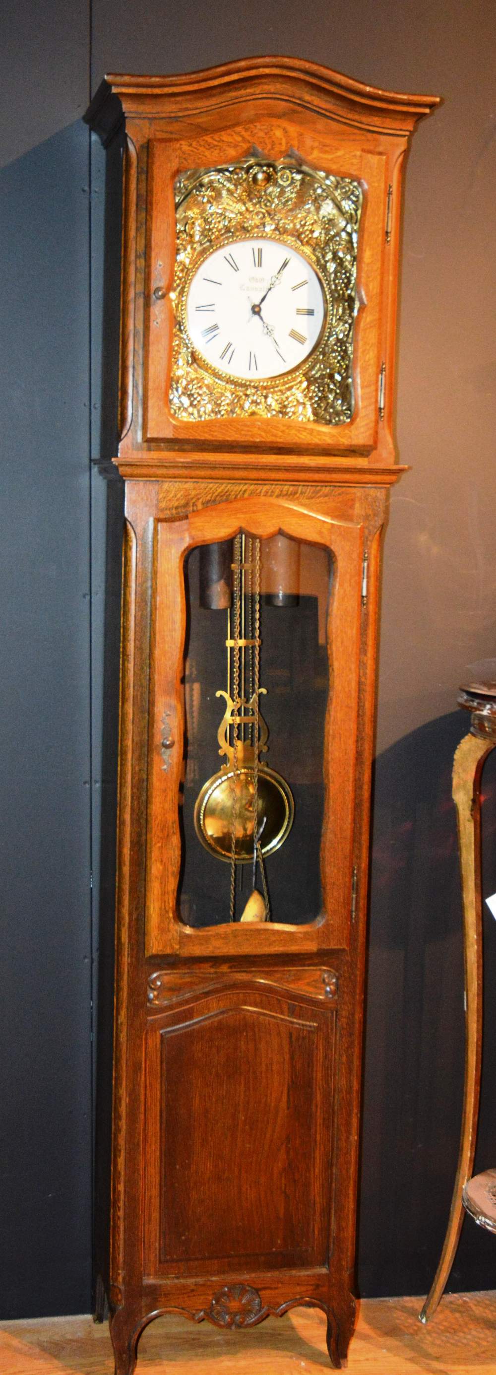 An oak cased old Lancelot longcase clock, with striking bell, the projected moulded cornice over