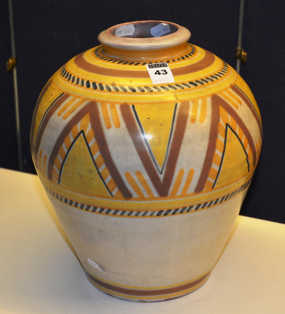 An Art Deco large Poole Pottery vase, decorated in yellows in a geometric design, stamped Carter