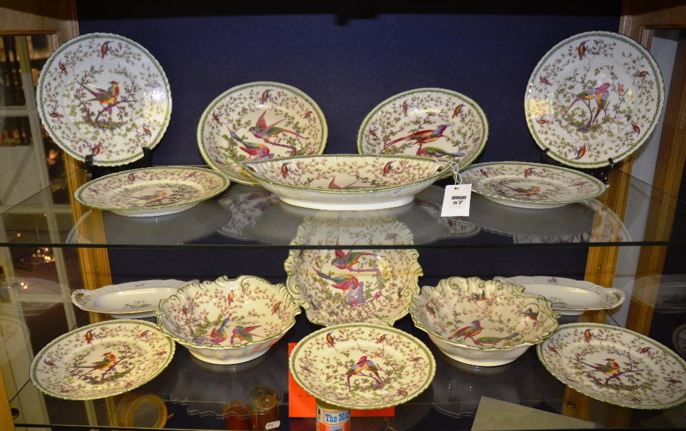 A part dinner service comprising plates and bowls decorated with exotic birds on branches, crown