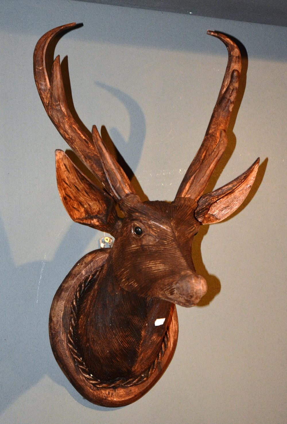 A carved wood stags head, on wall plaque, 38cm wide x 69cm high x 43cm deep