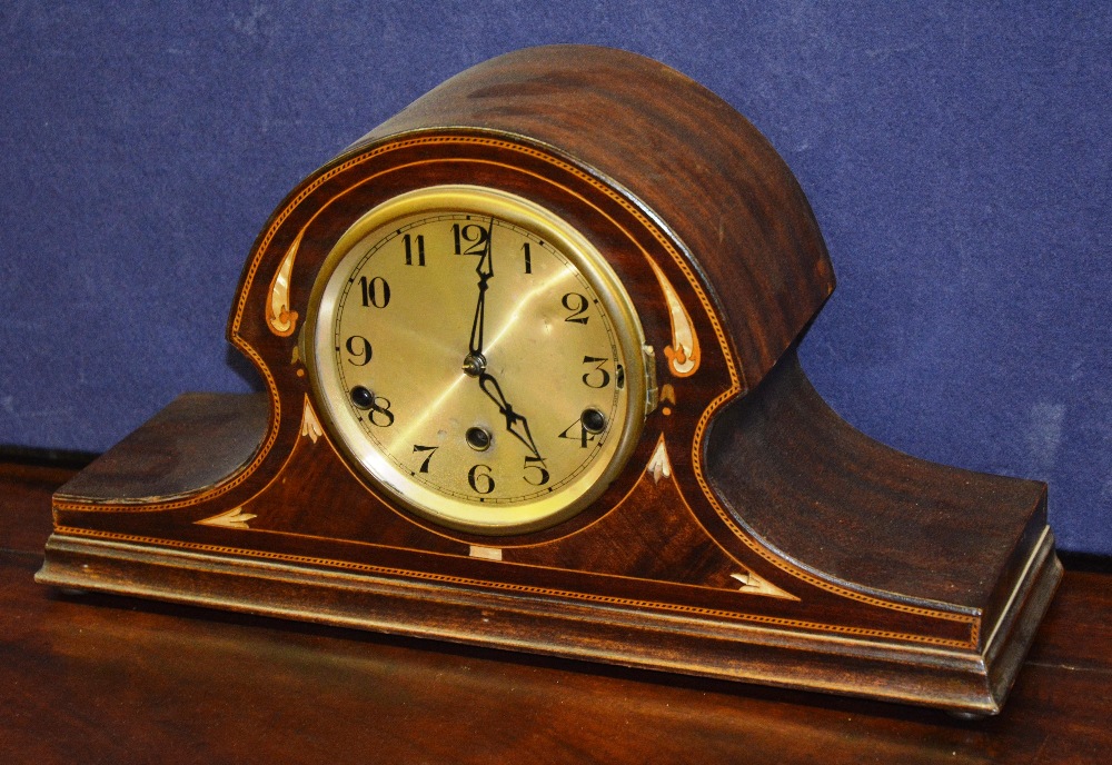 An Edwardian mahogany and inlaid mantle clock of arched form with brush metal face and Arabic