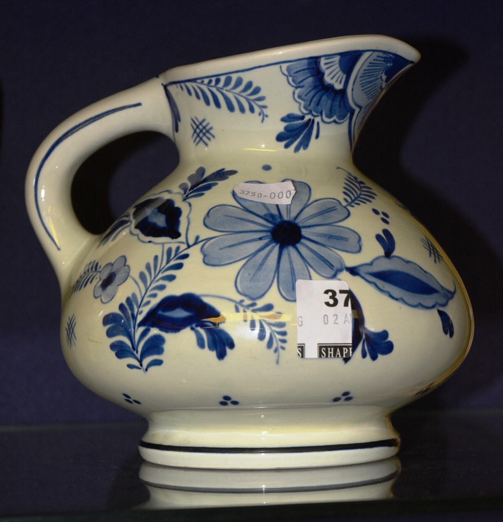 A blue and white Delft Maastricht jug decorated with flowers, 17cm high