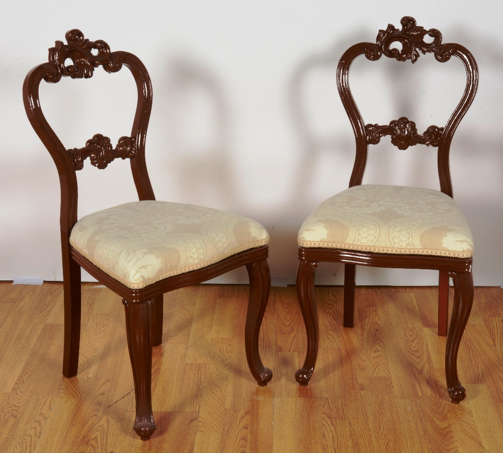 A set of eight overpainted Swedish side chairs each with foliate carved back, cushioned seat and