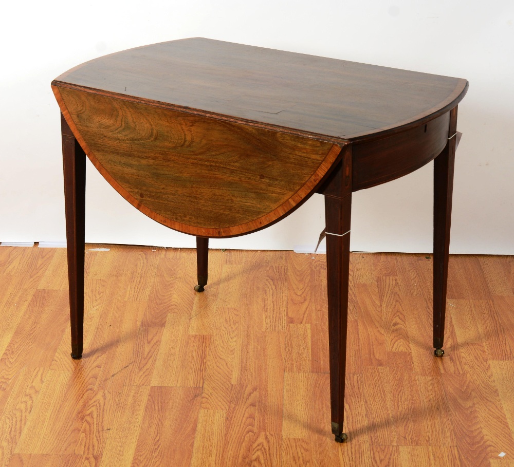 A Regency mahogany oval Pembroke table, the crossbanded and moulded top over frieze drawer, raised