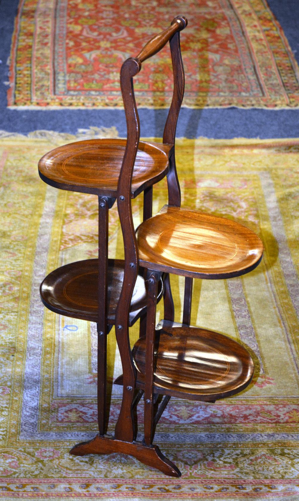 An Edwardian mahogany folding three tier cake stand, 77cm high