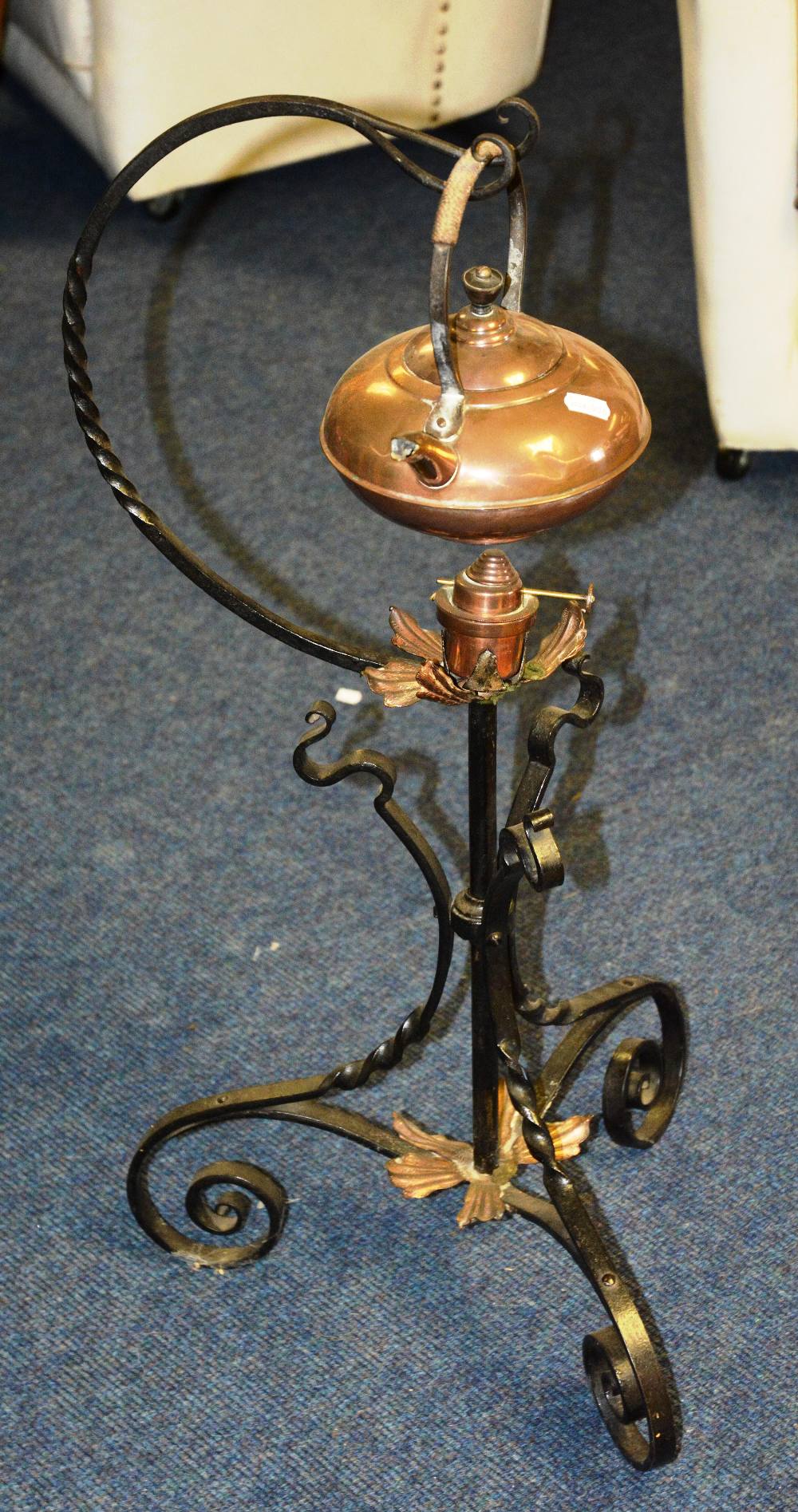 An aesthetic copper and metal work kettle warmer, the copper kettle on scrolling floor stand, with