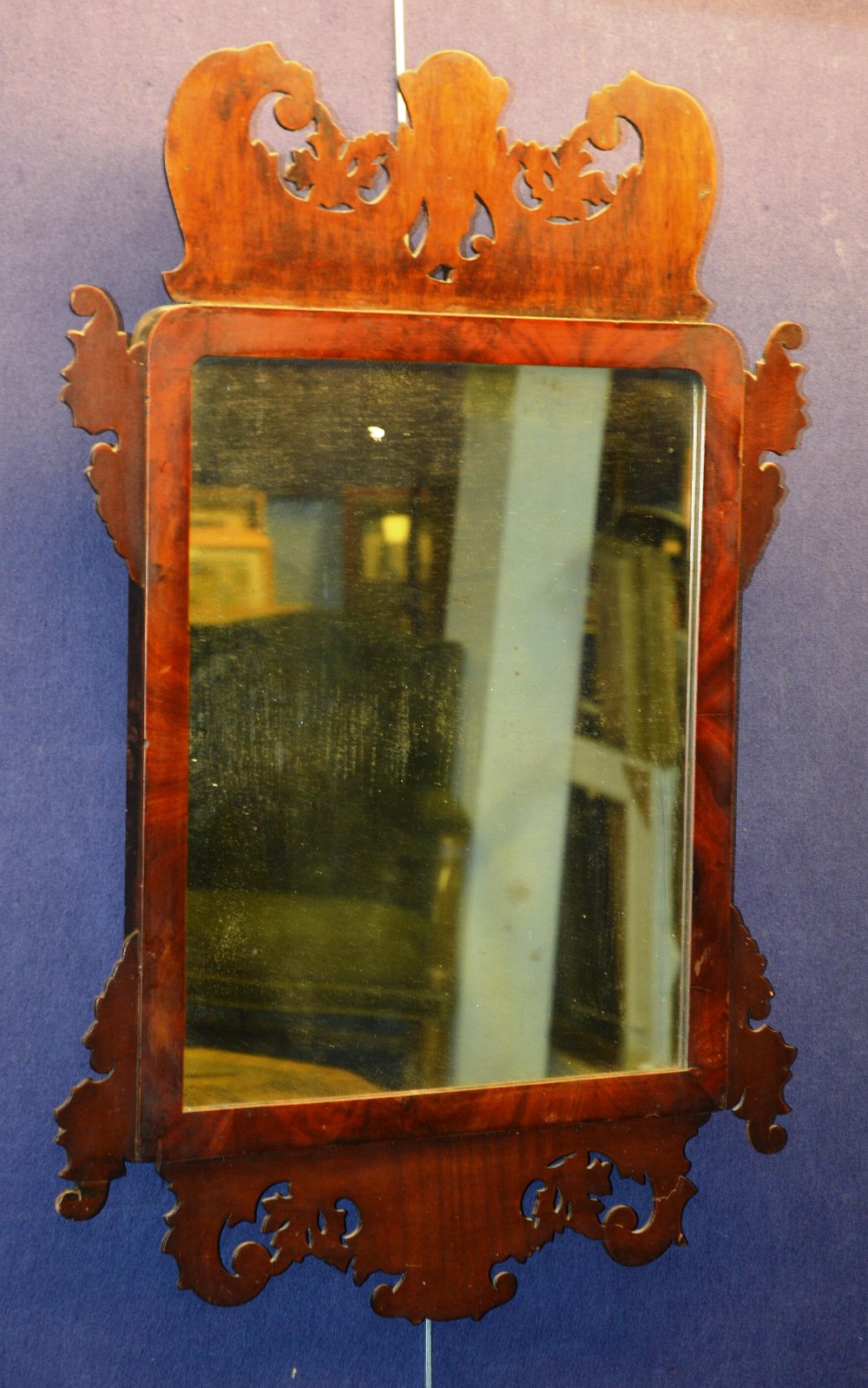 A Queen Anne walnut wall mirror, of rectangular form with scrolling pediment and brackets, 84 x