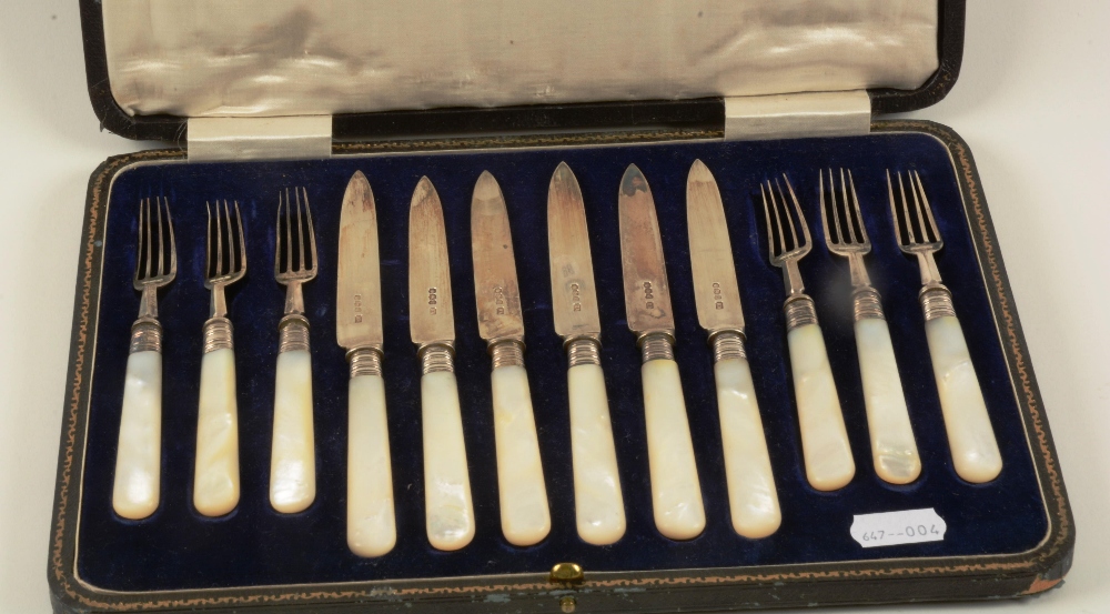 A boxed set of six Birmingham silver knives and forks with mother of pearl handles (12)