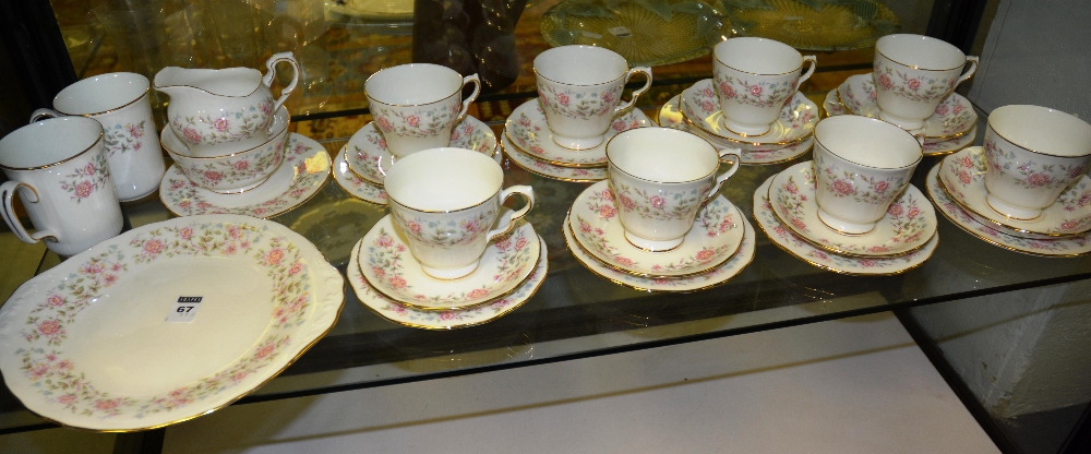 A Colclough 'Bouquet' tea set comprising eight trios, two mugs, side plate, cake plate, milk jug and