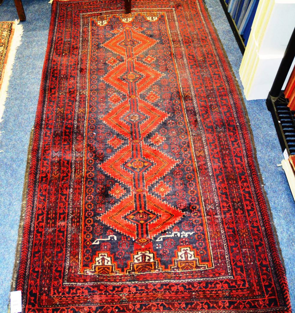 A Persian rug with five diamonds over blue ground and various borders, 183 x 94cm