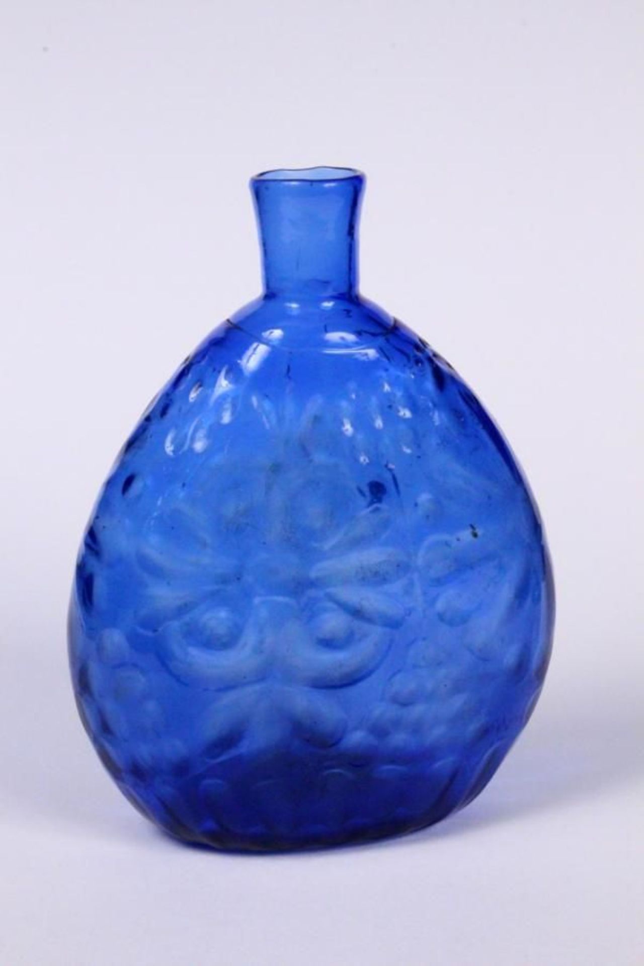 A BLACK FOREST BRANDY/SCHNAPPS BOTTLE 18th/19th century Blue glass with relief decoration, height