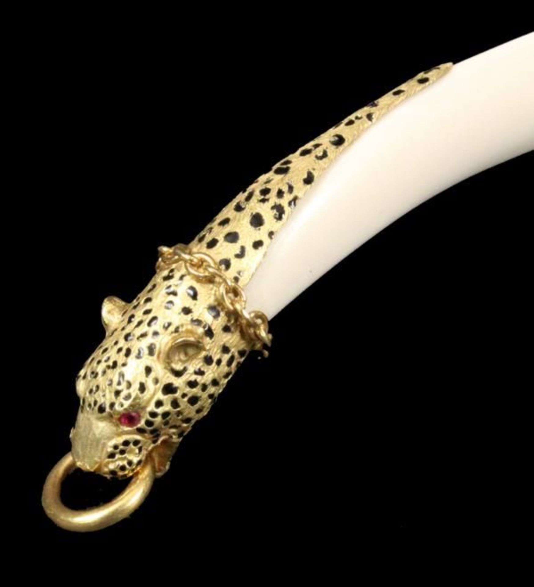 A LETTER OPENER probably Cartier, Paris A 750/000 yellow gold panther head with and ruby eyes and