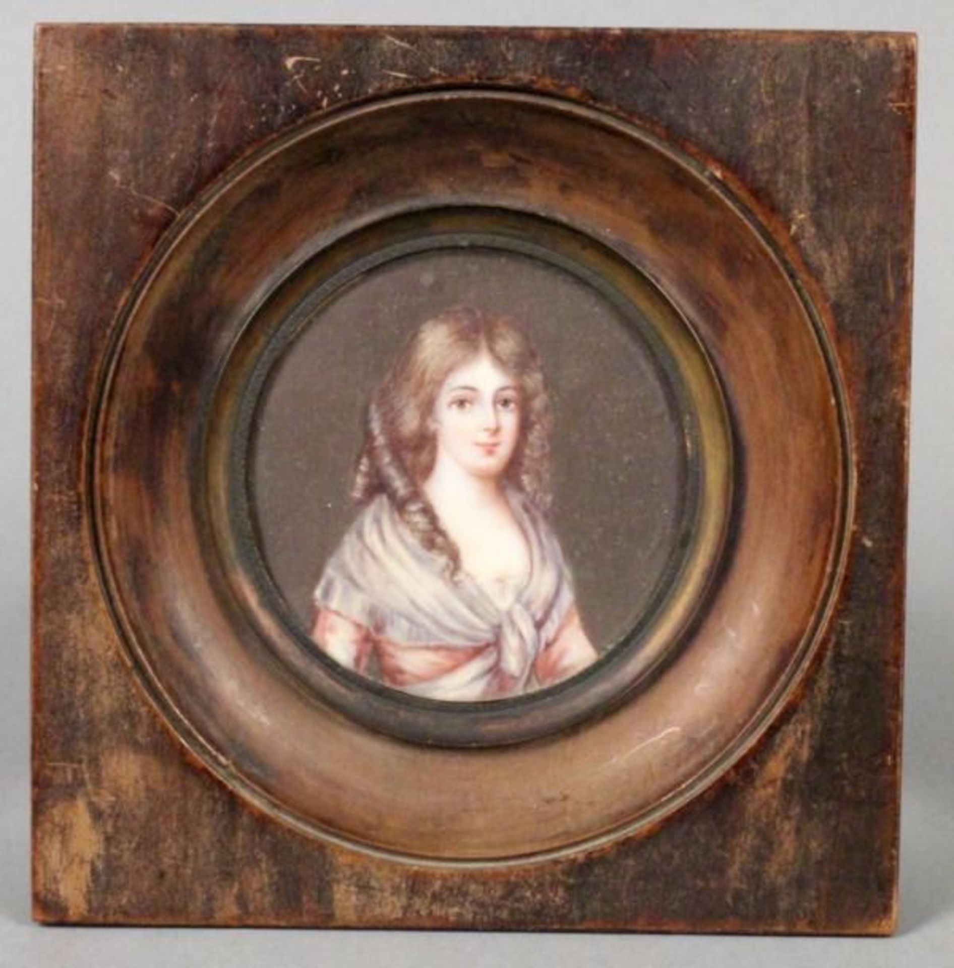 A PORTRAIT OF A GIRL Miniature on ivory, 13.5x13.5cm with wooden frame.    Starting price: 150