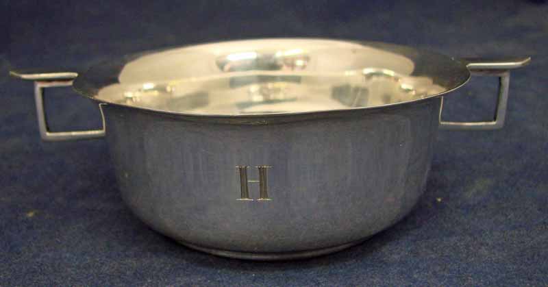 An early 20th century silver two handled porringer of circular form with flared rim and circular