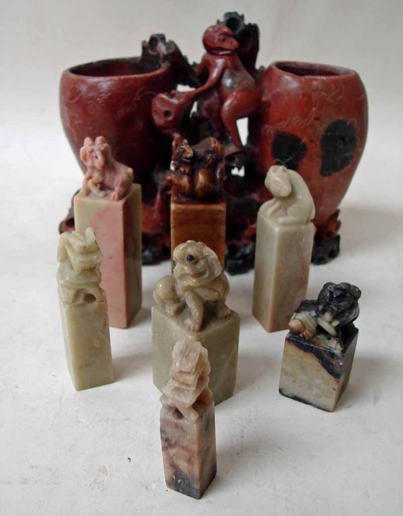 A collection of seven Chinese soapstone seals, each carved to the top with stylised animals, the