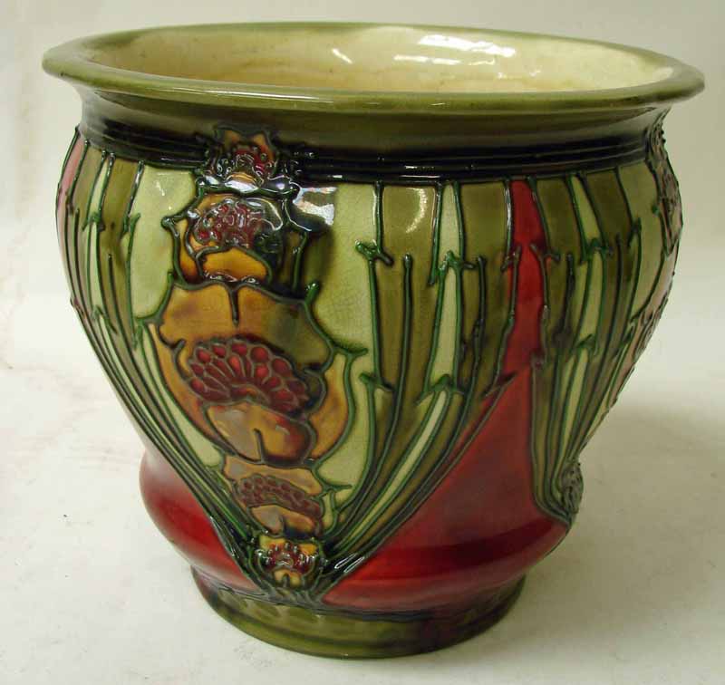 A Mintons pottery secessionist jardiniere of baluster form, tube lined design with stylised