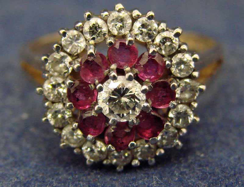 A 9ct gold dress ring of target form, set with a central diamond surrounded by a band of eight