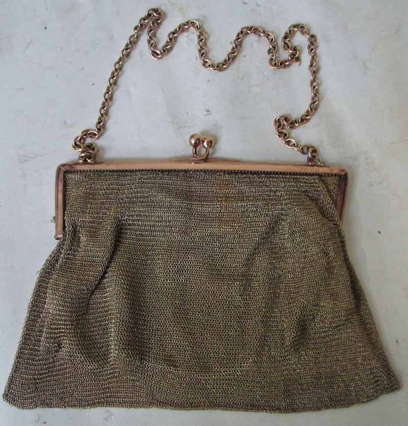 An early 20th century gold mesh evening bag, fine mesh link with chain handle and ball clasp, lined