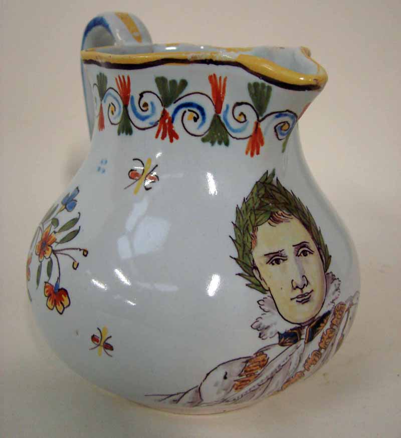 A 19th century French faience pottery jug, typically Quimper, polychrome decorated with floral