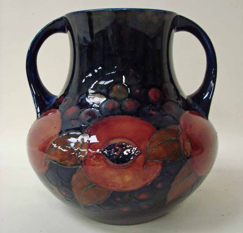 A large Moorcroft pottery two handled vase of bulbous form, tubeline decorated in the Pomegranate