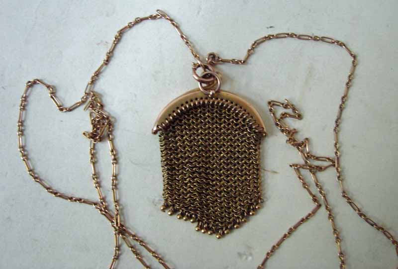 An early 20th century gold mesh sovereign purse, fine mesh link with ball clasp marked 9ct,